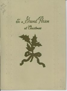 Holiday card featuring an illustration of several leaves tied together with ribbon, reading "To a Grand Person at Christmas"