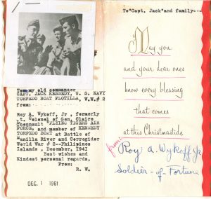 Holiday card featuring a black and white photograph of several military members reading "To my old commander Capt. Jack Kennedy, US Navy Torpedo Boat Flotilla, WW#2, from Roy A. Wykoff Jr, formerly Lt. Colonel of Gen. Claire Chennault Flying Tigers Air Force, and member of Kennedy Torpedo Bat at Battle of Manilla River and Corregidor World War #2 - Philipines Islands, December 1941, Best wishes and kindest personal regards, from R.W."